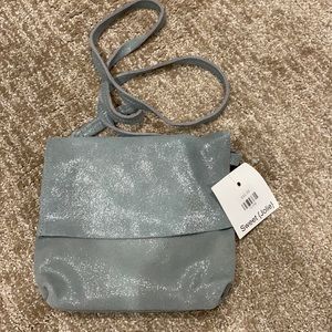 New with tags. Shimmer grey/blue leather purse.